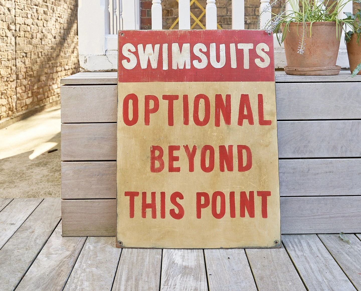 Swimsuits optional beyond this point hand painted sign