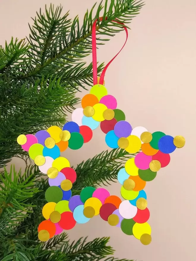 Large Rainbow Star Christmas Ornament.  Star shape outline with red ribbon hanging loop