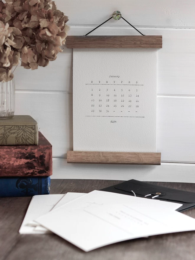 Small wall calendar in wooden print hanger