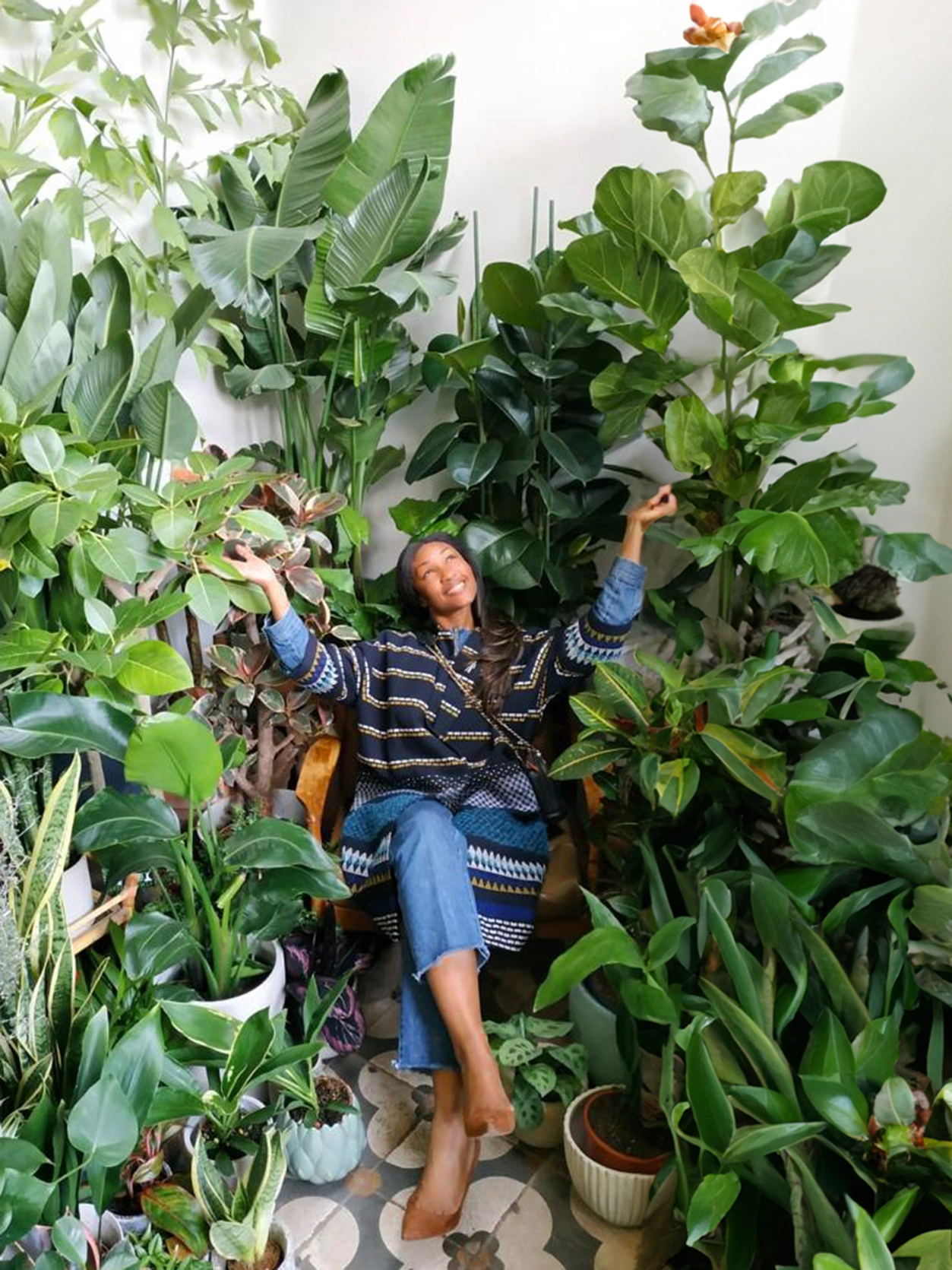 Happy Heads founder surrounded by plants
