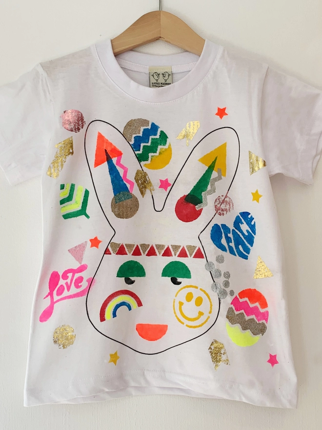 Tshirt printed with bunny head filled with colourful stencilling and gold metallics