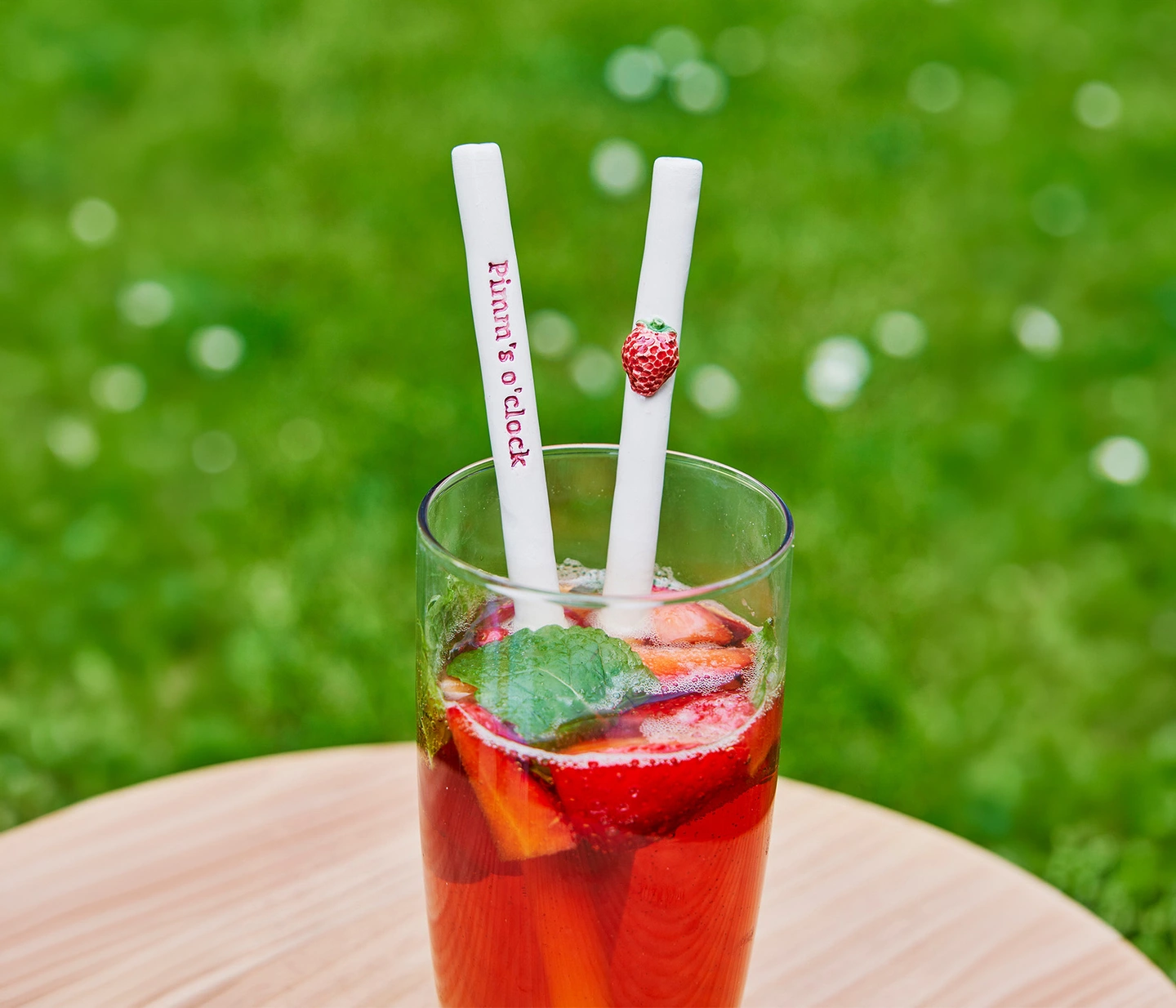 Pimms ceramic straw on a picnic basket in the garden