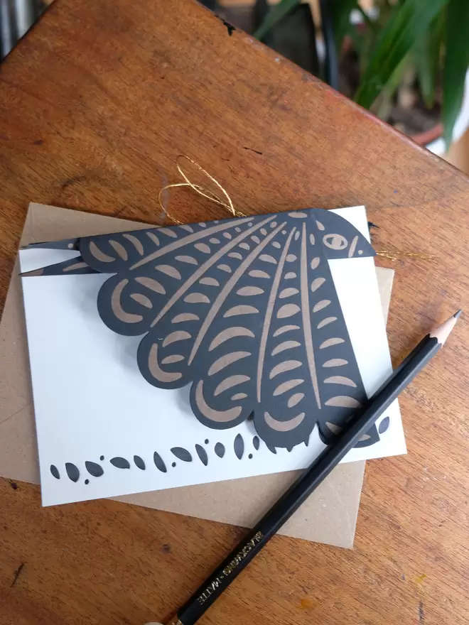 Black and gold letterpress printed bird decoration – folded flat to the size of an A6 card. White notecard and kraft envelope.