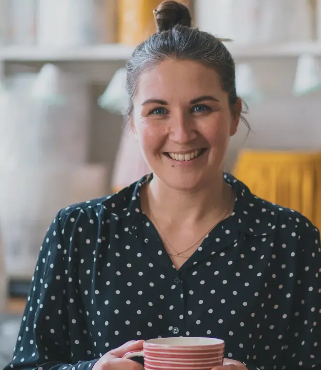 Jo, founder and maker of lume lighting, smiling at camera