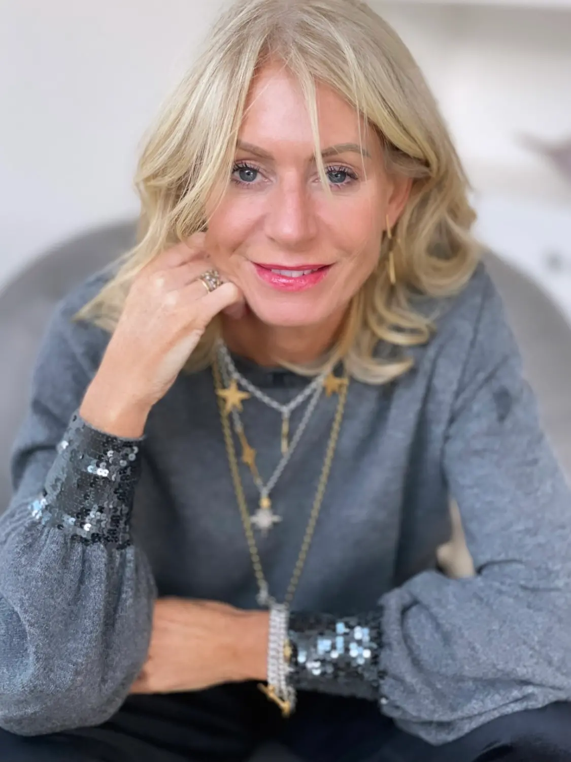 Jewellery designer Amy Elson wearing layered silver necklaces