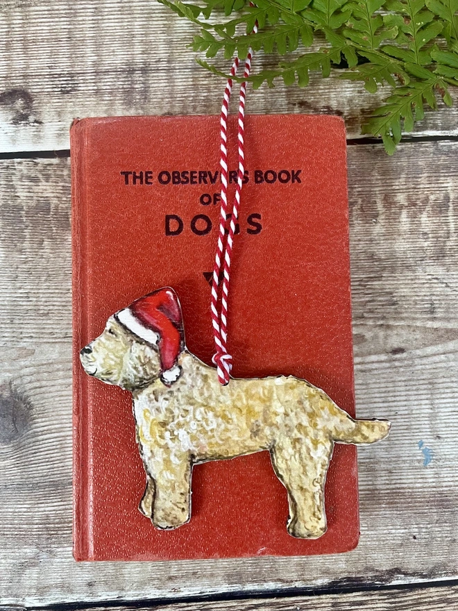 Cockapoo Christmas decoration laid on a book 