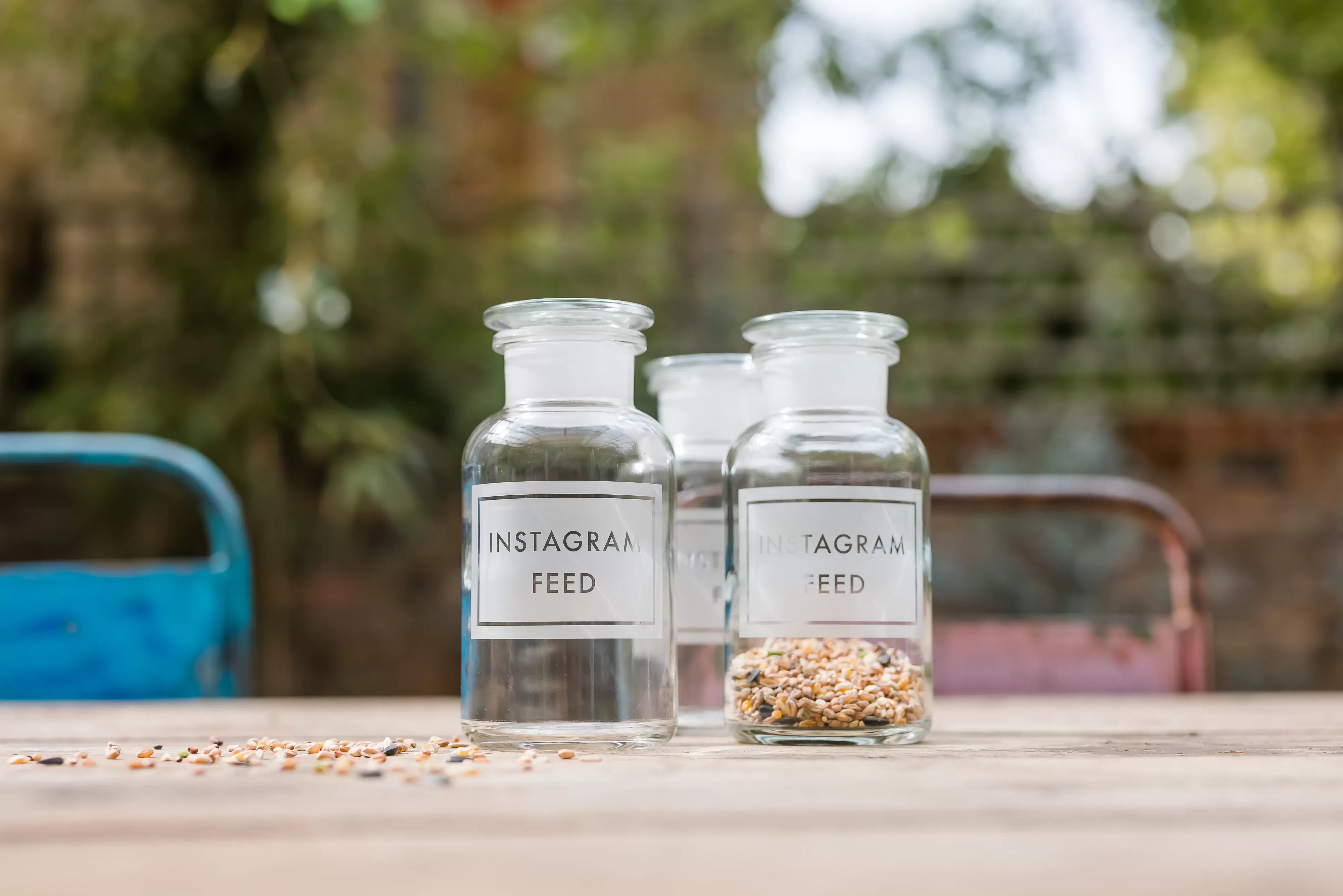Glass jars with Instagram Feed engraving on a wooden table 