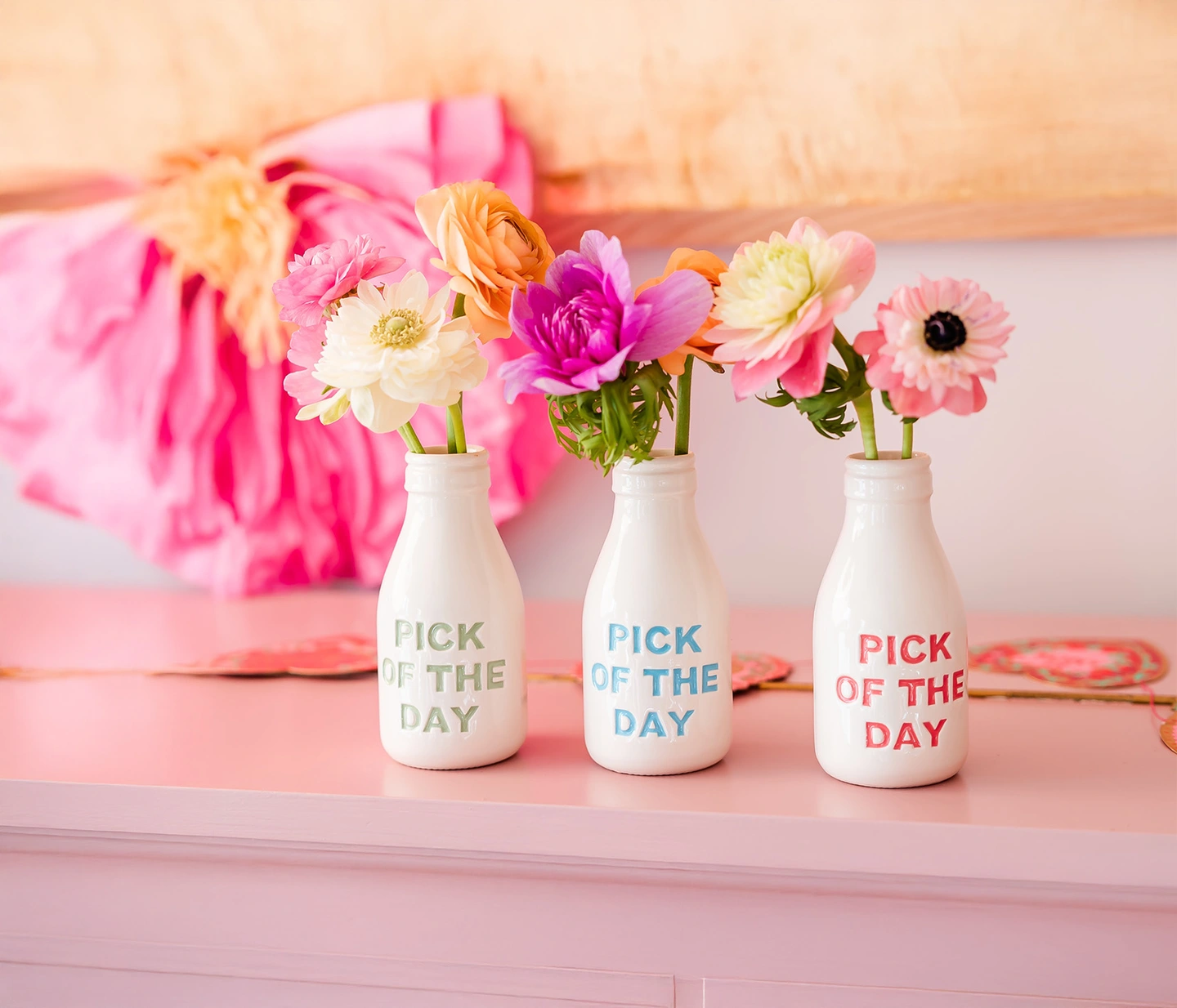 Pick of the day ceramic vases. Ceramic bottle shaped vases with coloured lettering saying 'pick of the day' on the front.