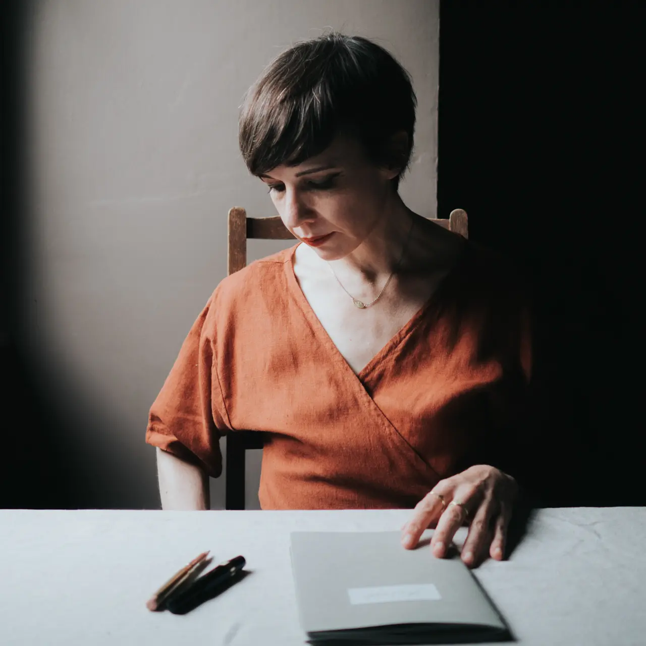 Gaelle Jolly sitting at a table with a notebook and pens in front of her