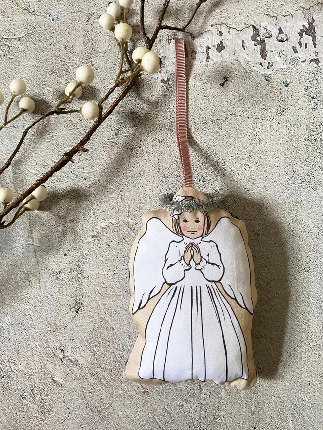 angel plush Christmas decoration featuring a praying angel with a tinsel halo