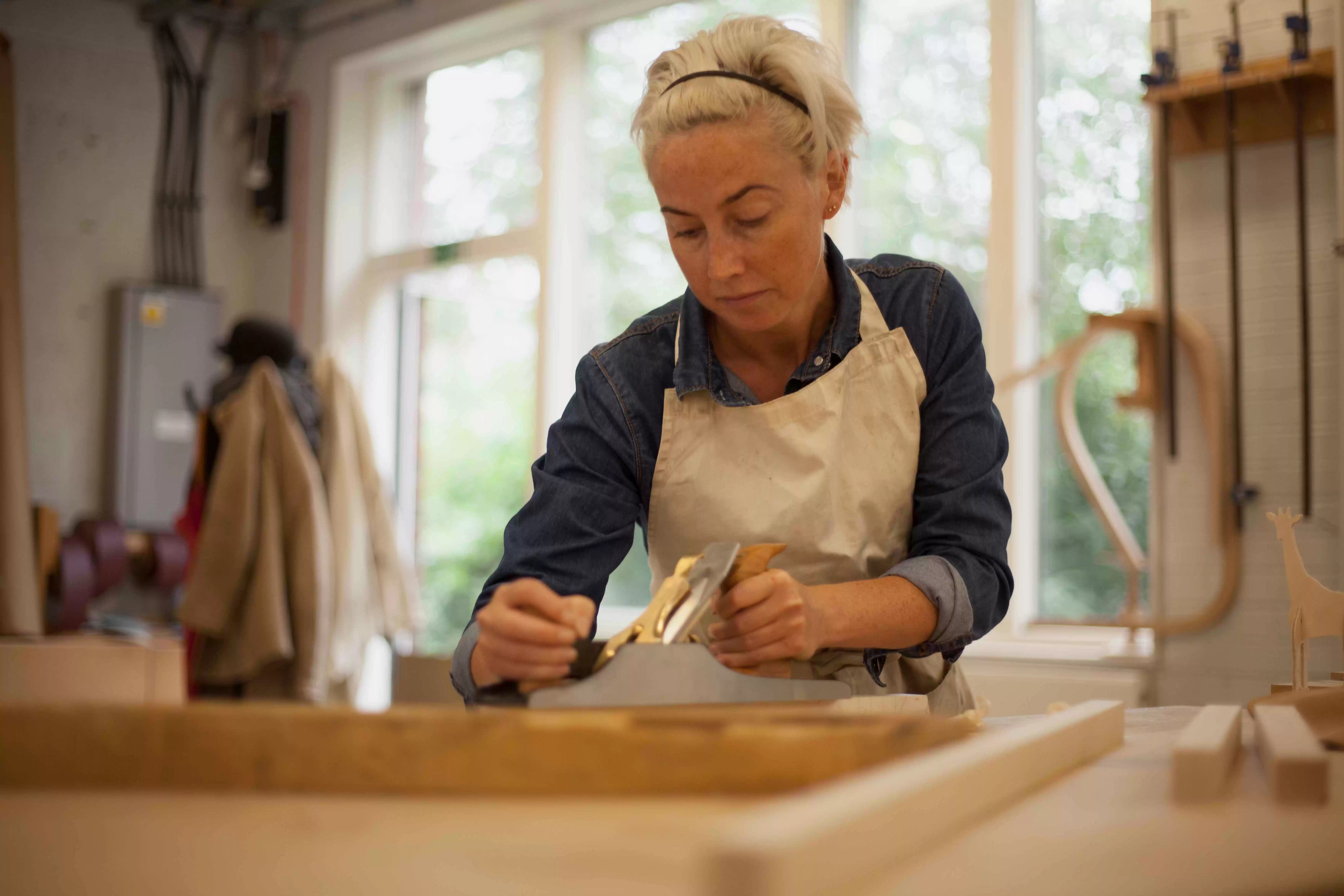 woodworker planing timber furniture