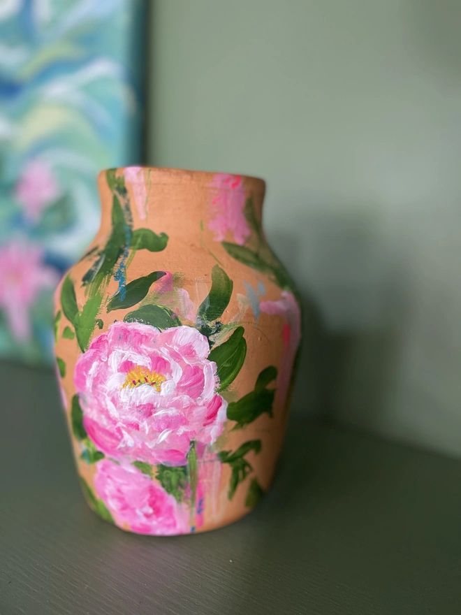 close up photo, hand thrown terracotta dried flower vase hand painted pink peony blooms