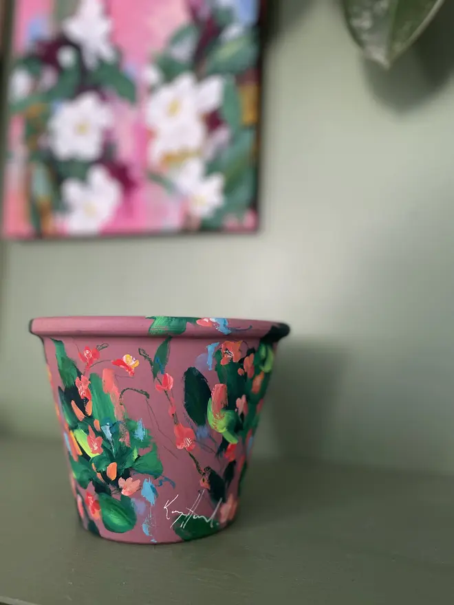 hand painted floral plant pot mauve background, twizzle coral flowers