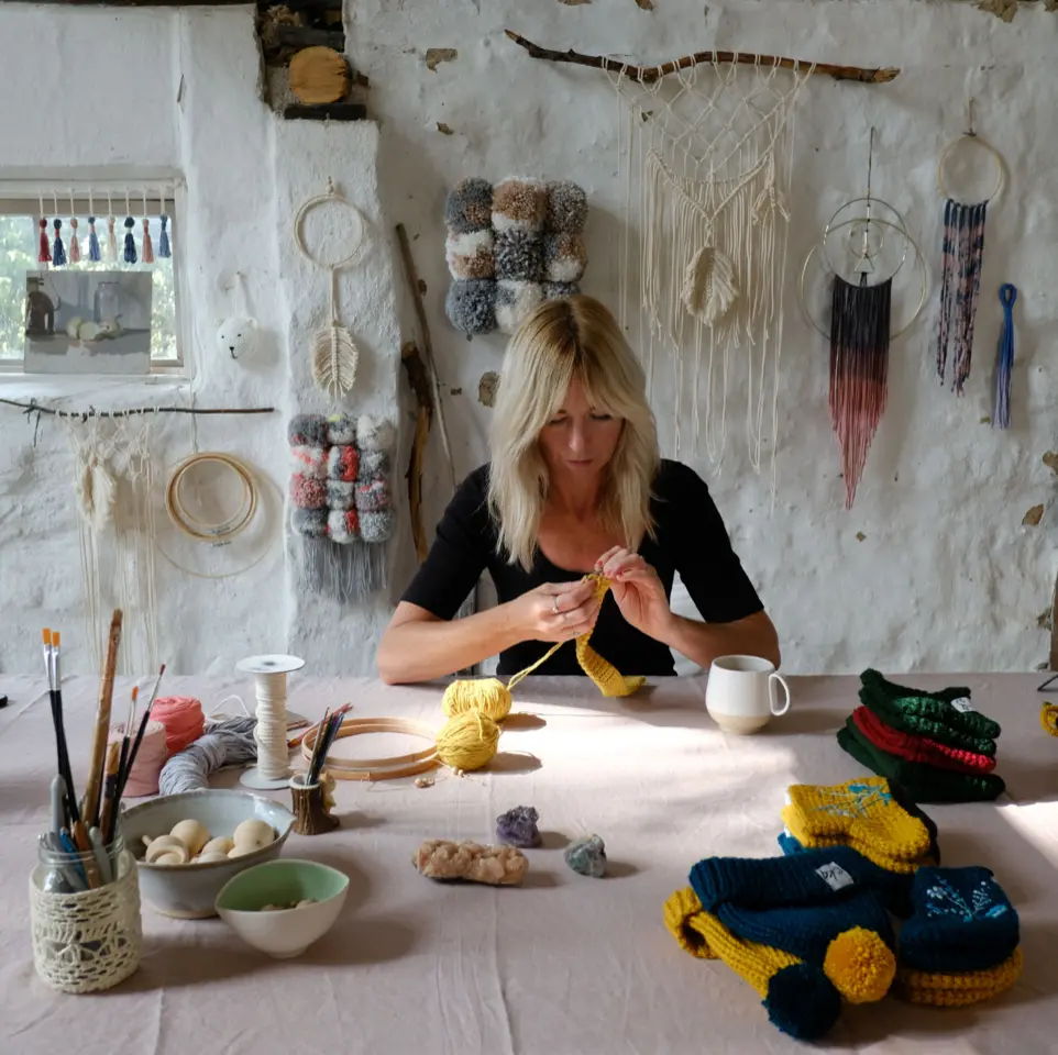 Woman crocheting in studio space