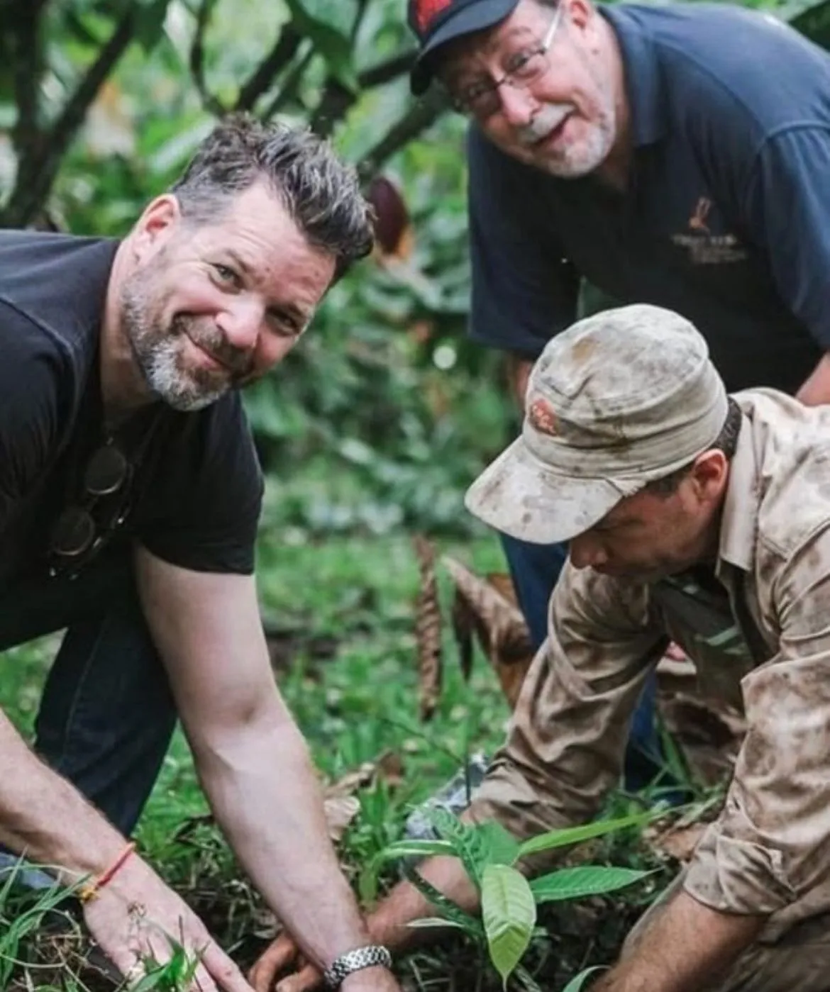 gavin with cacao plants and farmers