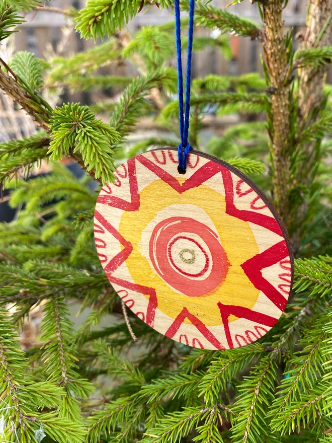 Esther Kent hand painted wooden circle decoration in red and yellow