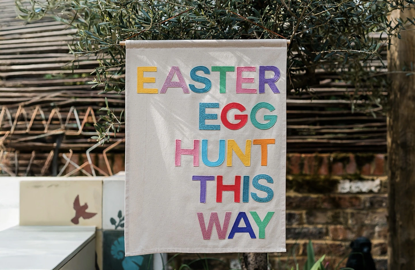 Easter egg hunt this way felt banner. A felt banner which says Easter egg hunt this way in multicoloured letters