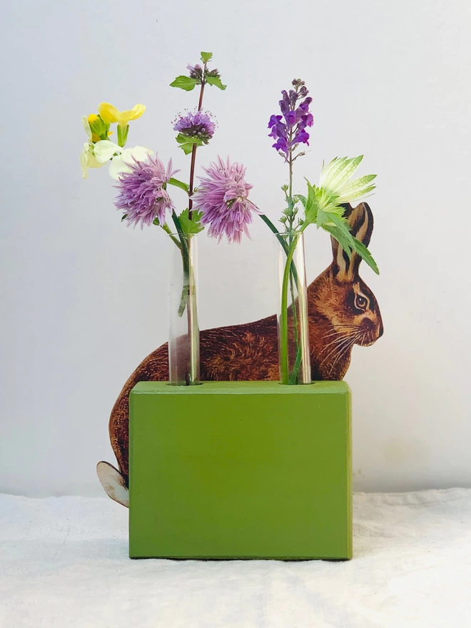 A test tube bud vase with hare decoration.