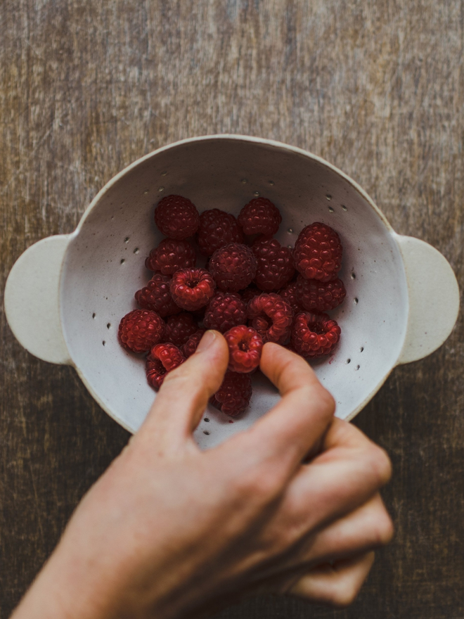 raspberries in handmade stoneware bowl