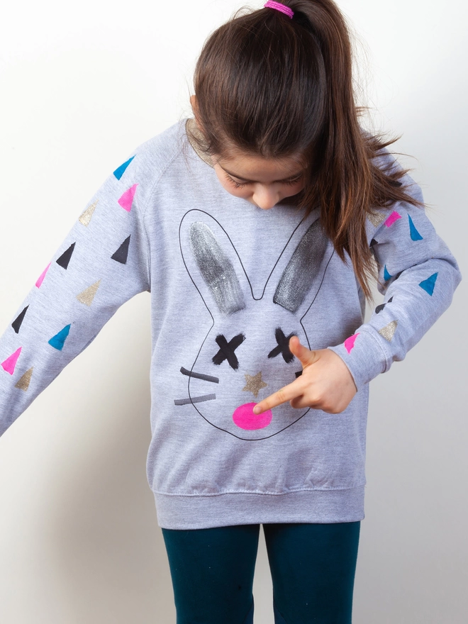Girl wearing a printed Bunny sweatshirt painted on with stencils