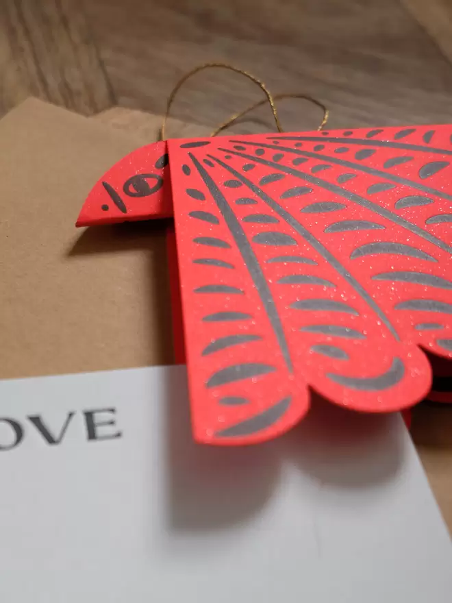 Red folded letterpress bird with 'Love' notecard and string and washer envelope.