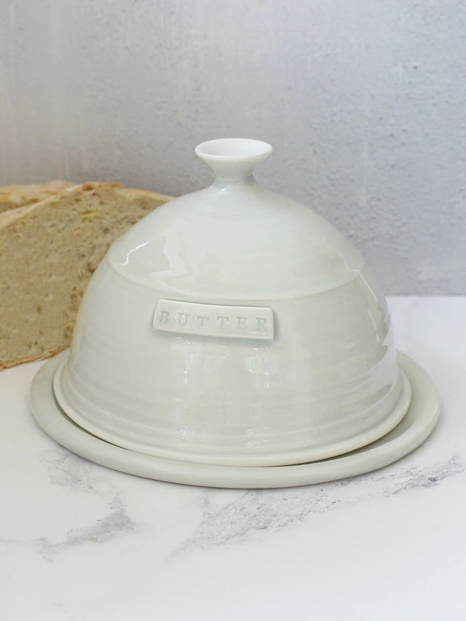 domed grey butter dish with bread slices