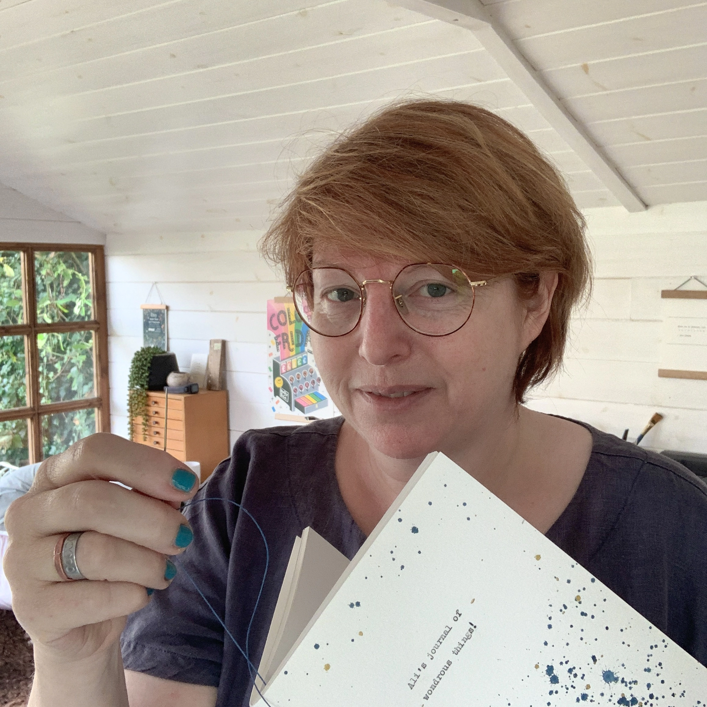 Michaela in her studio, stitching a  personalised notebook