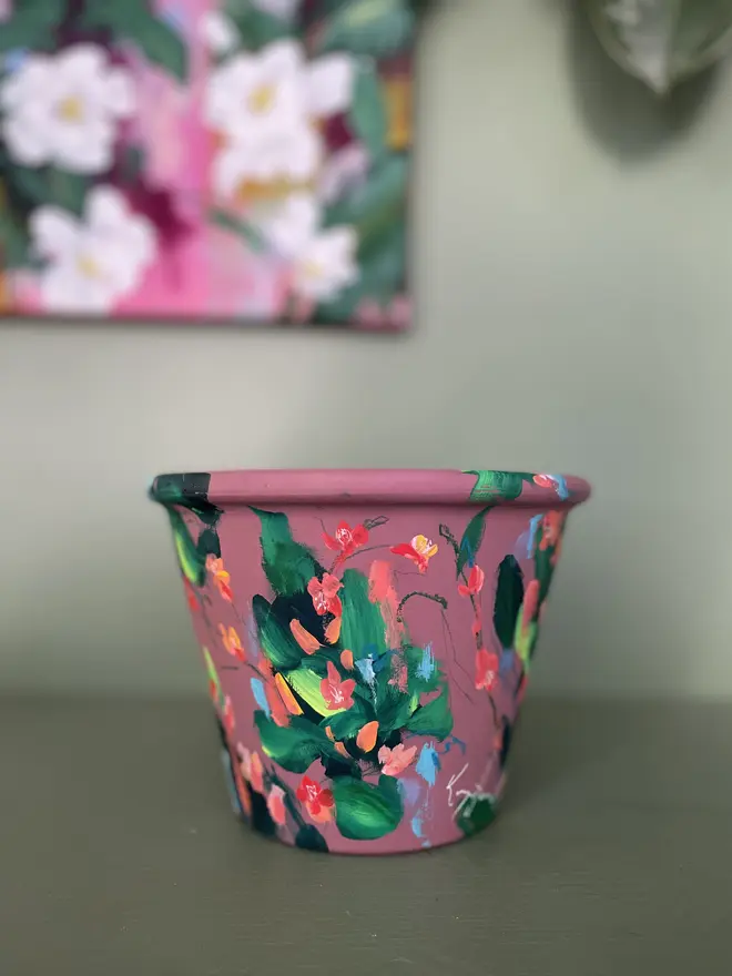 hand painted floral plant pot mauve background, twizzle coral flowers 