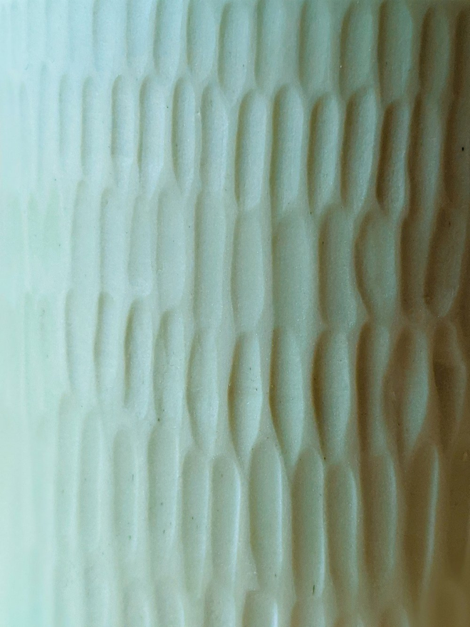 handmade textured pale blue vase close up