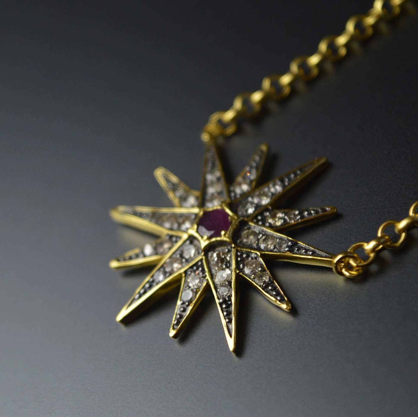 Gold start necklace with diamond and central ruby