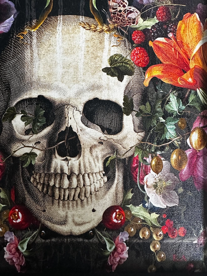 Close up of fine art print on canvas showing detail of skull and floral art