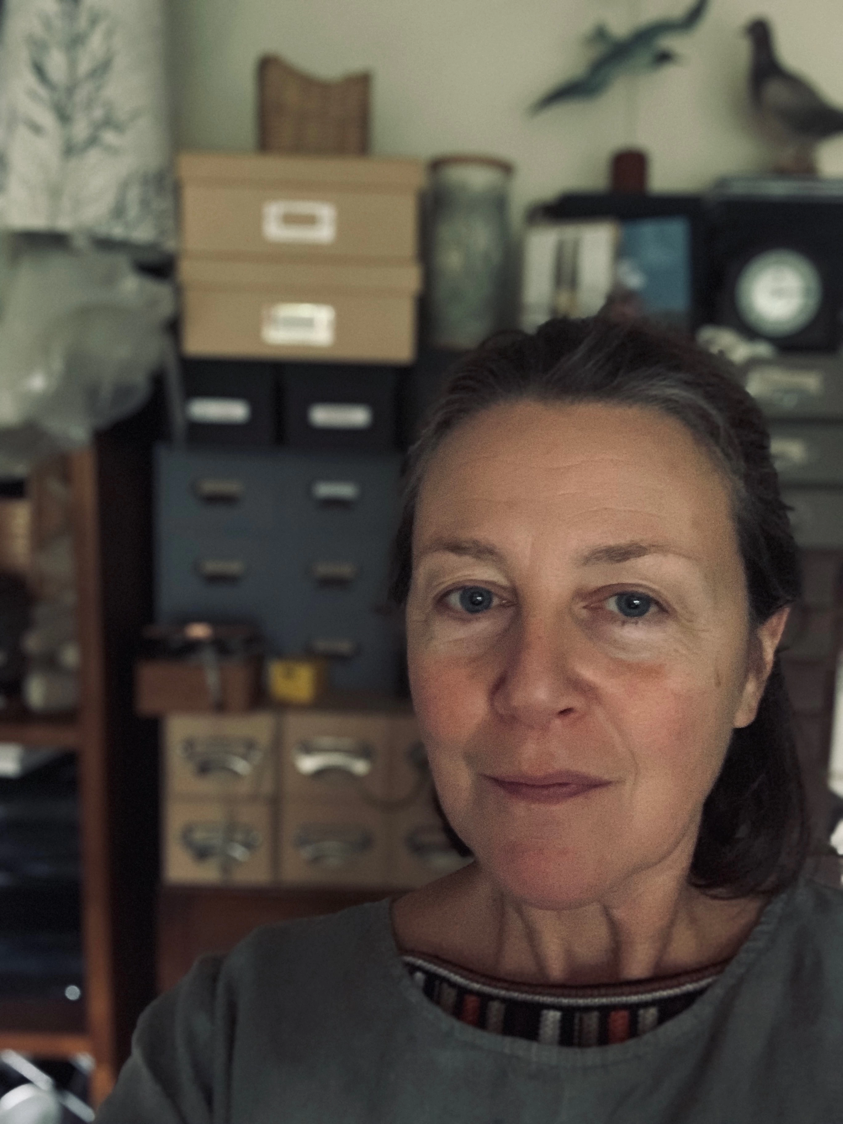 Karen Kench of Kettle of Fish Designs in her studio in front of many filing drawers