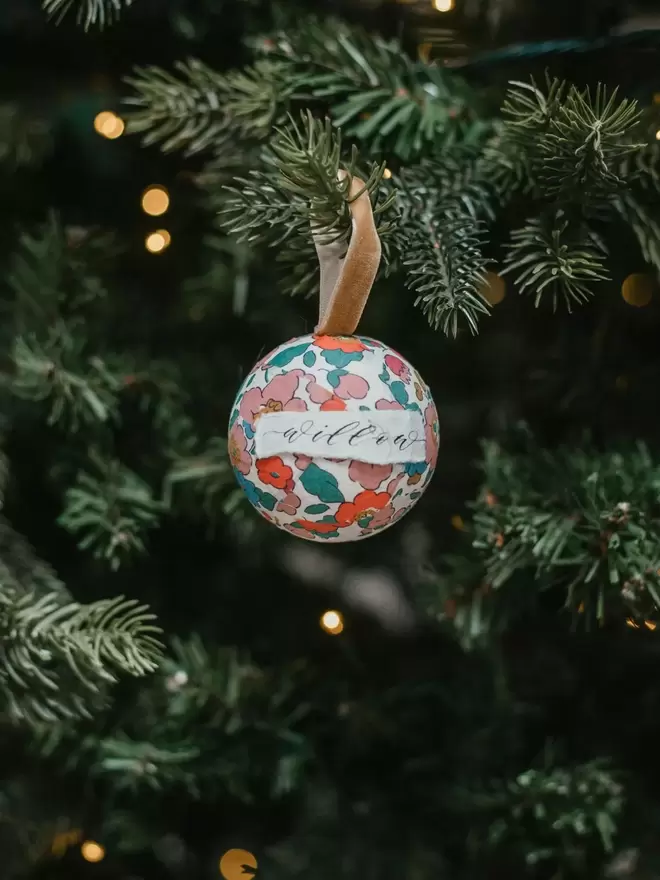 Personalised mini Liberty bauble hanging on a Christmas Tree