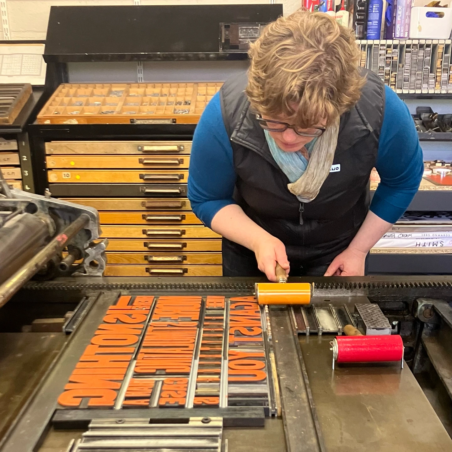 Hand inking wood letters for letterpress posters