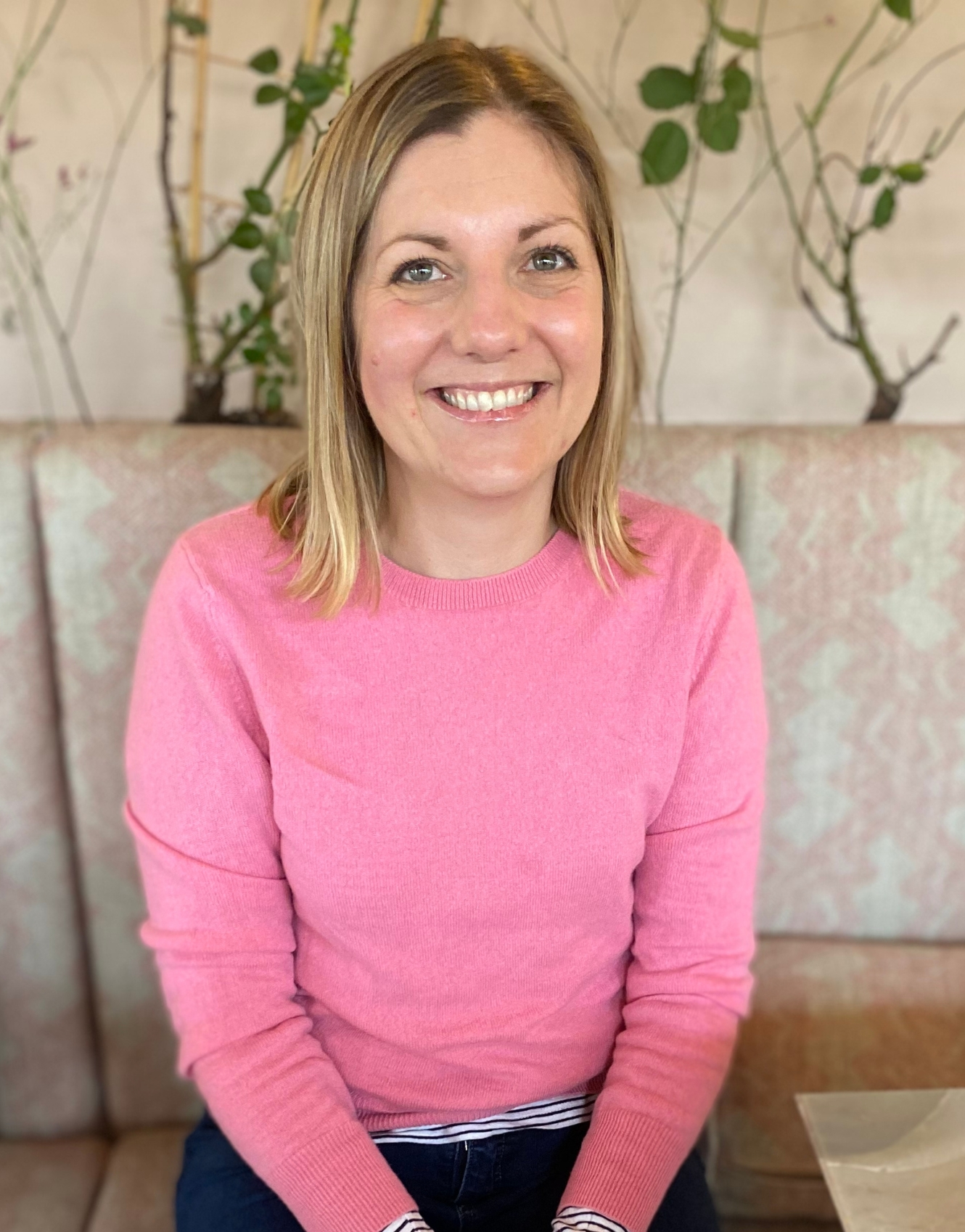 Sarah Guild Floral Design smiling wearing a pink jumper 