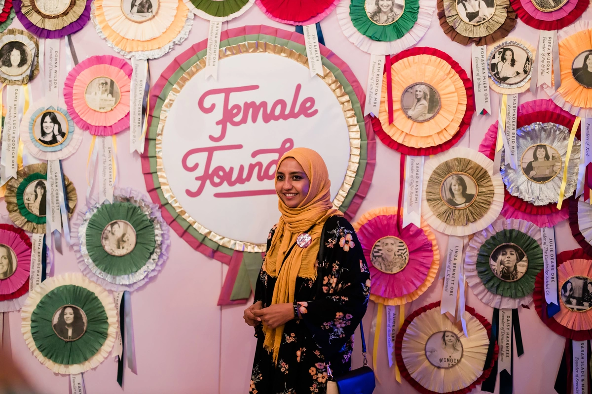 Pink female founder wall with female founder rosettes
