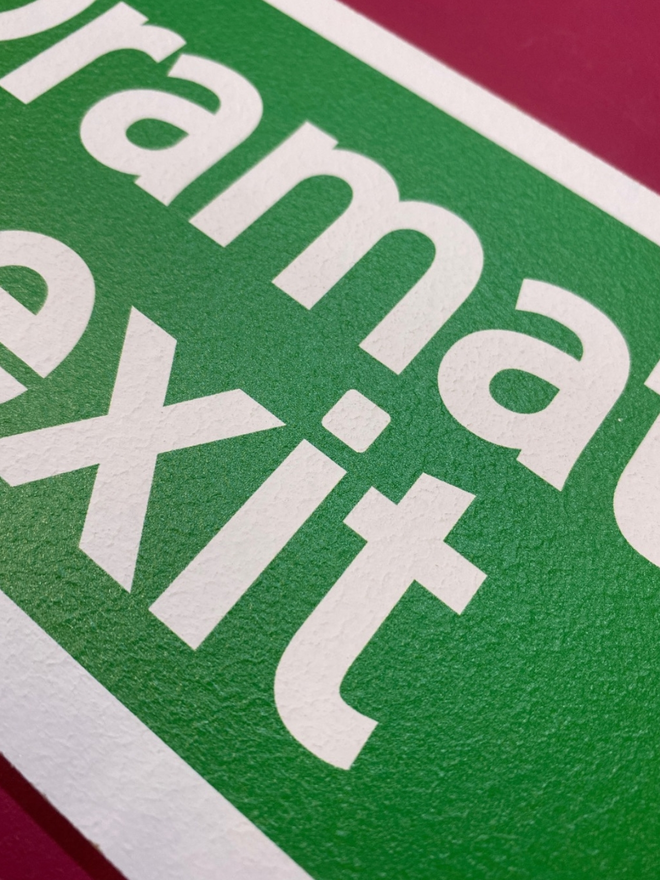 Surface texture of green Dramatic Exit Sign 