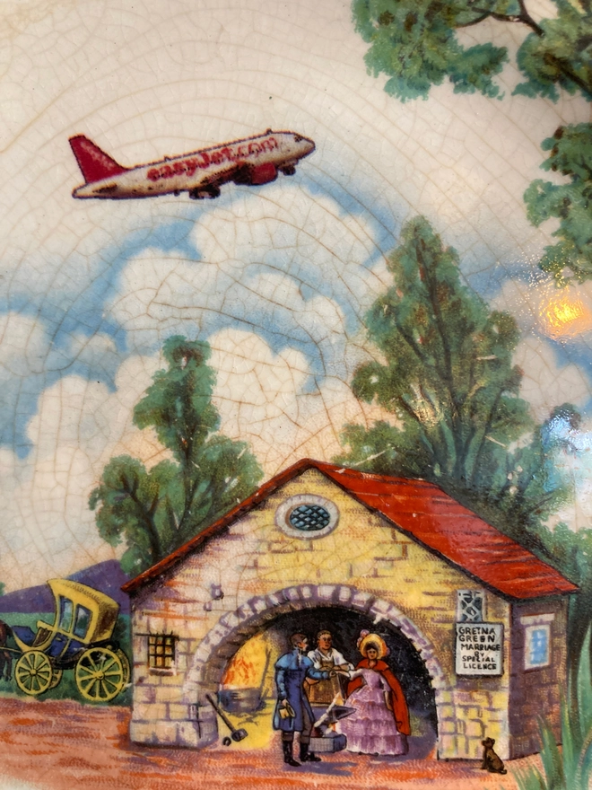 vintage plate featuring a couple getting married in a chapel at Gretna Green while an easyJet plane flies overhead.
