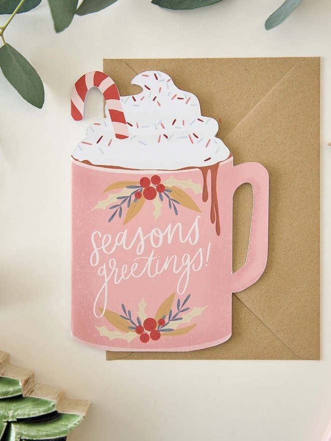 Seasons greetings illustrated pink cutout hot chocolate Christmas card