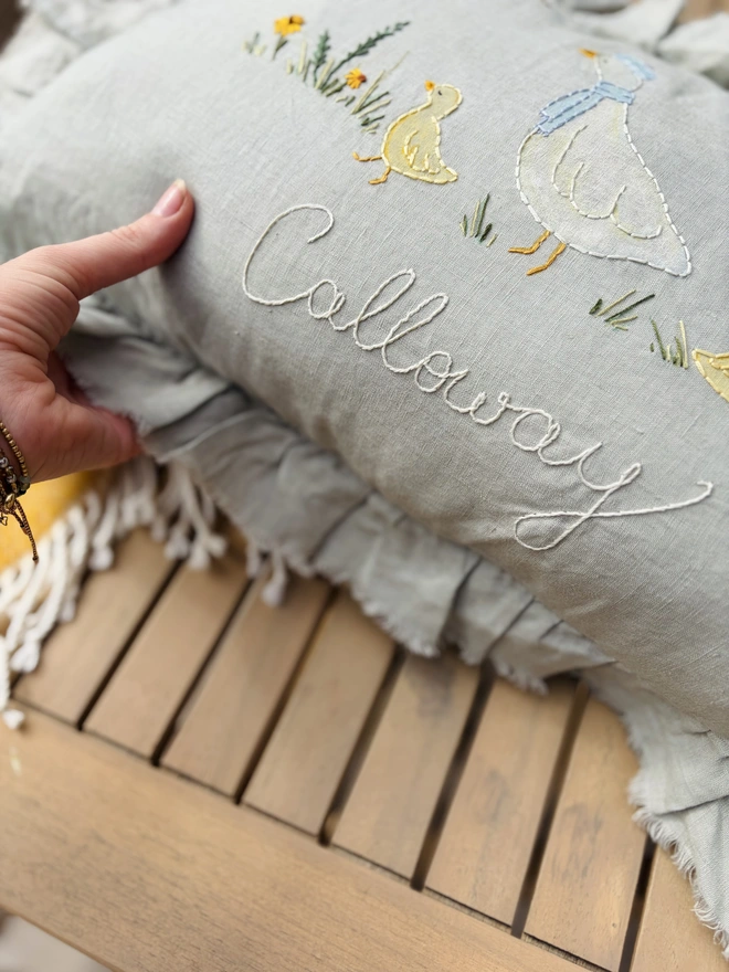 Hand Painted and Hand Embroidered Goose with baby geese on green linen cushion. Yellow flowers and bees. 
