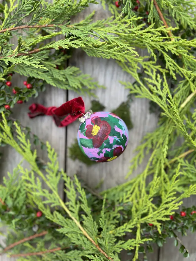 a set of six hand vibrant painted floral ceramic baubles all painted with an array of winter florals each finished with a luxurious velvet ribbon 