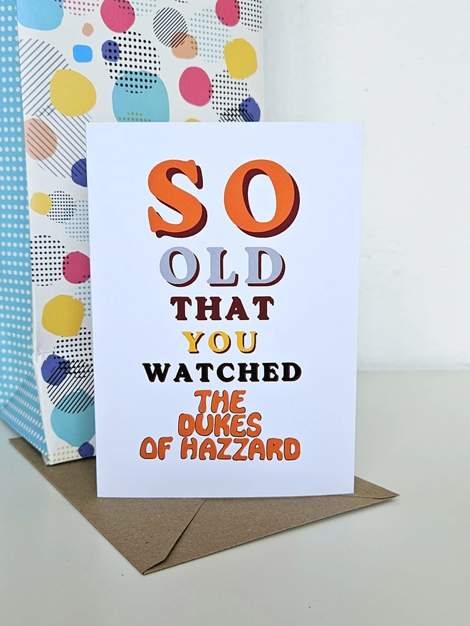 A nostalgic card that says So old that you watched The Dukes of Hazzard in colourful retro style fonts on a white background.