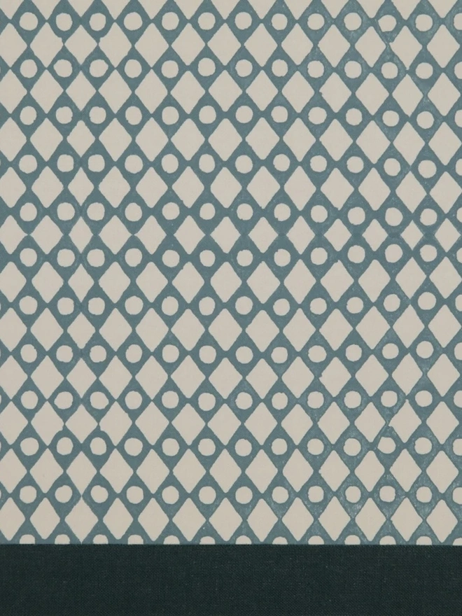 Retro Drum Lampshade. Close-up of a hand block printed lampshade showing a bold repeating geometric pattern. The colourful printed design and neat trim bring character and a handcrafted finish to any lamp.