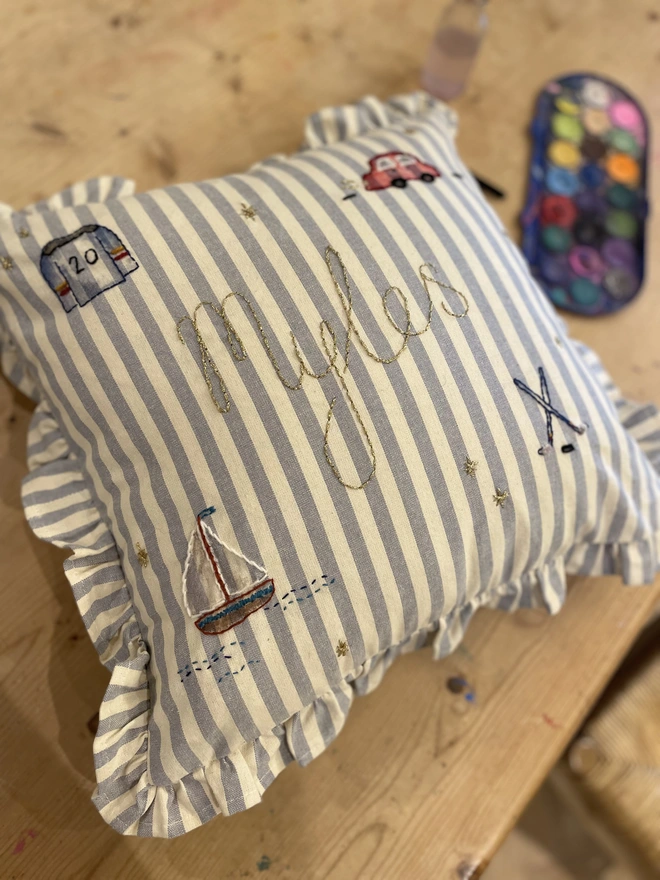 Blue stripe ruffle cushion with hand embroidered details. Personalised design 