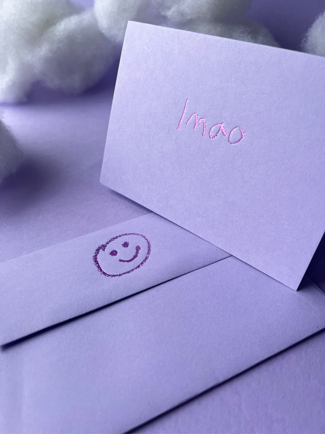 lavender coloured card with lmao  short for 'laugh my ass off' hand foiled in kids hand writing
