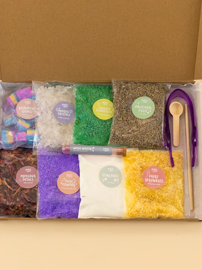 fairy sensory potion kit. nine bags of various sensory materials placed into a cardboard box.