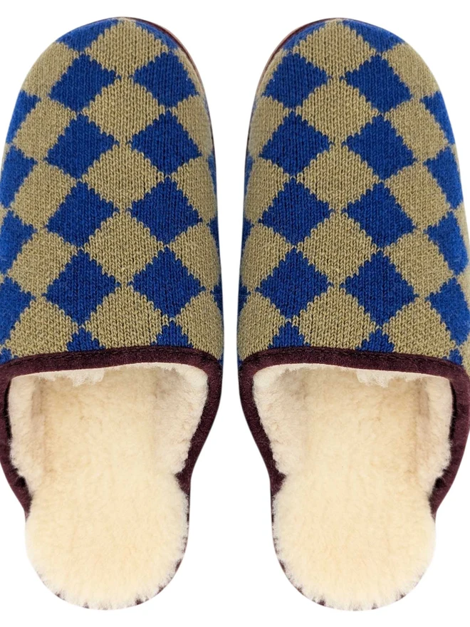 Lambswool & Sheepskin Slippers, a pair of colourful lambswool and sheepskin slippers sitting on a plain white surface. 
