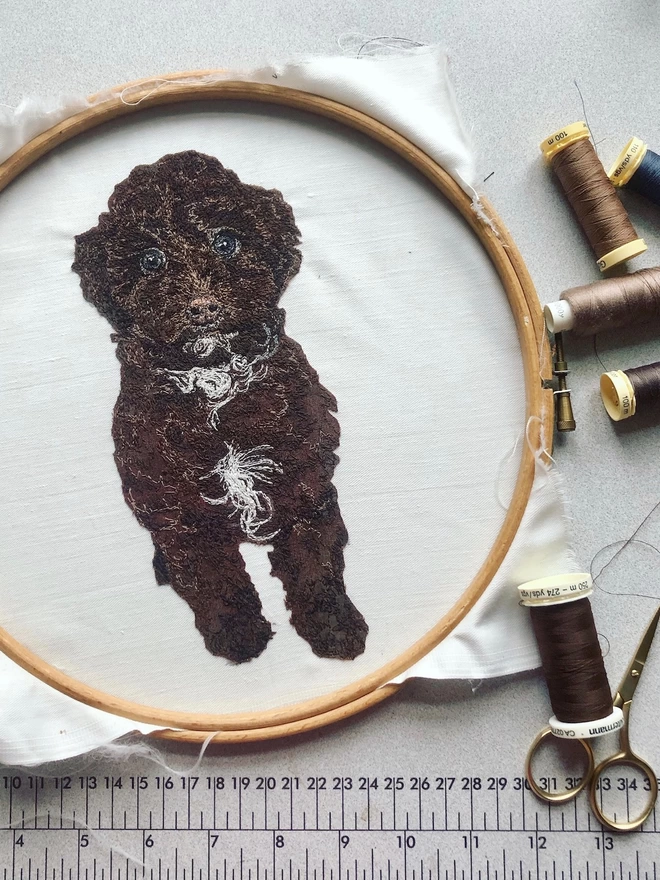 photo showing the making of an embroidered pet portrait of a small brown cockerpoo puppy