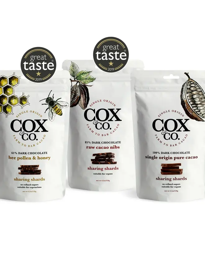 Cox&Co Sharing Shards Pouch - Single Origin Pure Cacao, a trio of chocolate pouches sitting on a table surface. 