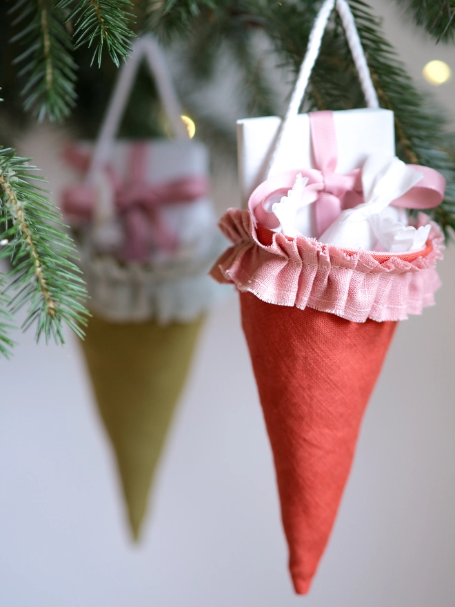 Reusable Victorian Christmas gift cones for hanging beneath festive greenery, featuring delicate ruffled trim.